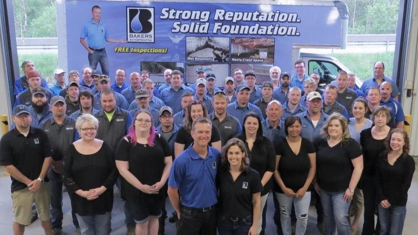 bakers team smiles in front of work truck