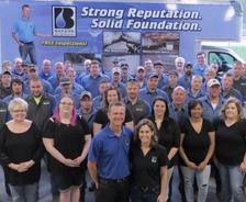bakers team smiles in front of work truck