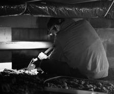 crew member digging in crawl space