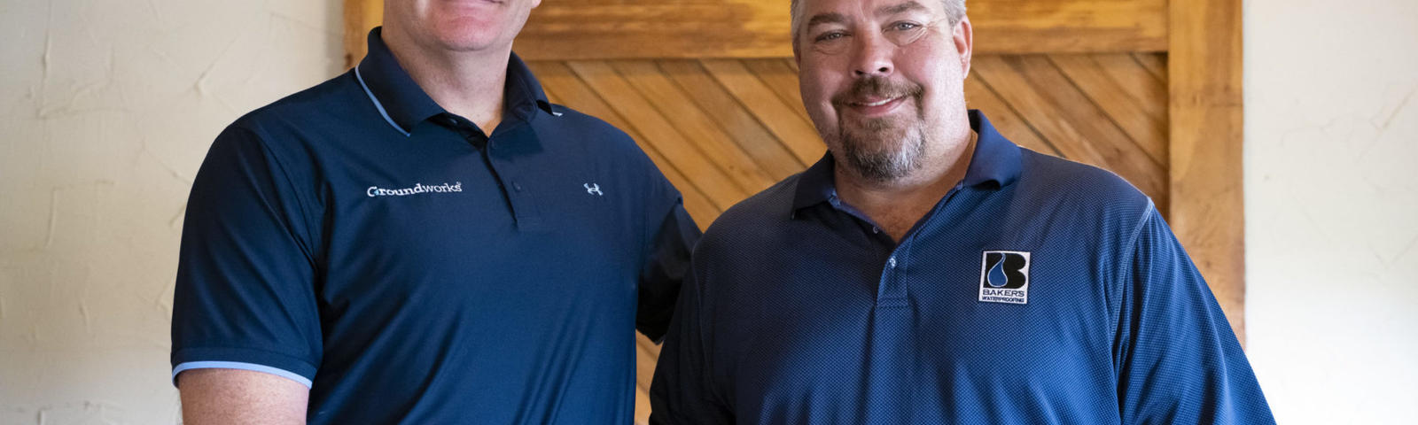 Matt Malone shaking hands with Baker's Waterproofing Owner; Jake Waltz