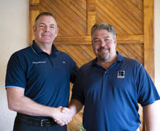 Matt Malone shaking hands with Baker's Waterproofing Owner; Jake Waltz