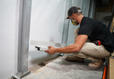 Baker's Waterproofing crew member installing basement gutters.