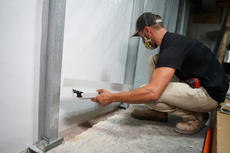 Baker's Waterproofing crew member installing basement gutters.