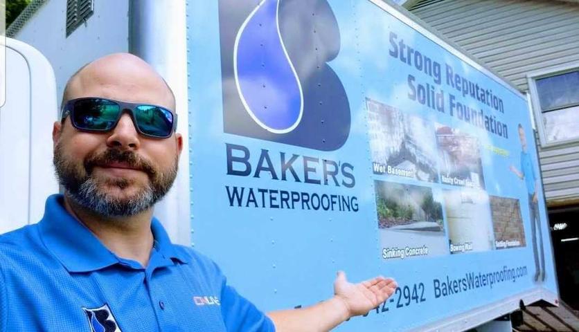 Baker's Waterproofing employee standing in front of Baker's box truck