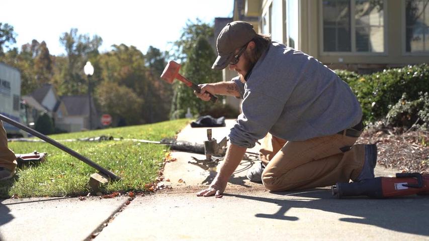 CFI installing poly to level concrete sidewalk