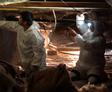 Baker's crew members inspecting crawl space.