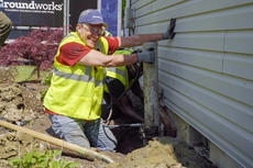 Mike helps install a push pier while laughing