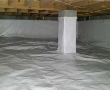 A clean, sealed crawl space with a white vapor barrier covering the floor, walls, and support pillars.