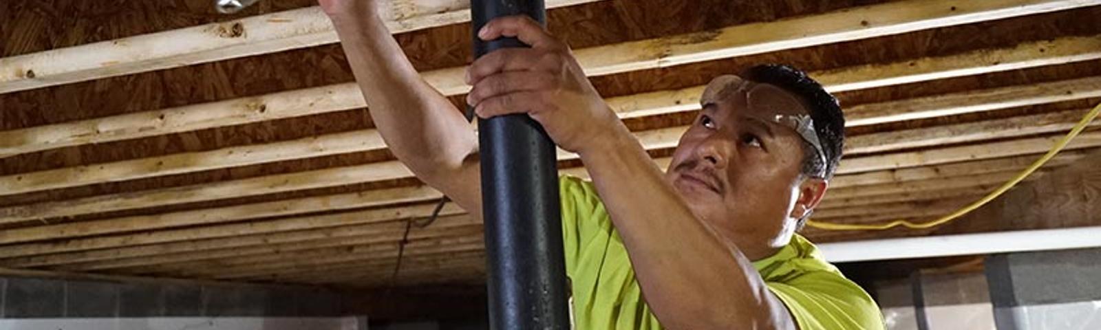 worker installing crawl space supports