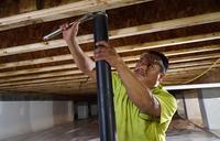 worker installing crawl space supports