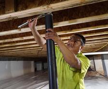 worker installing crawl space supports