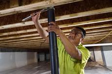 worker installing crawl space supports
