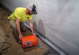 Crew installing Basement drain