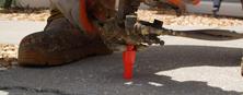 AFS crew member conducting a PolyRenewal injection into concrete slab.