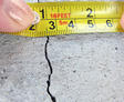 A crack in a poured concrete wall that's showing a normal crack during curing in Daphne