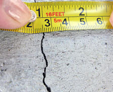 A crack in a poured concrete wall that's showing a normal crack during curing in Daphne