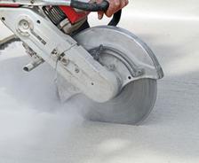 Cutting the driveway for expansion joints during street creep repair in Phenix City