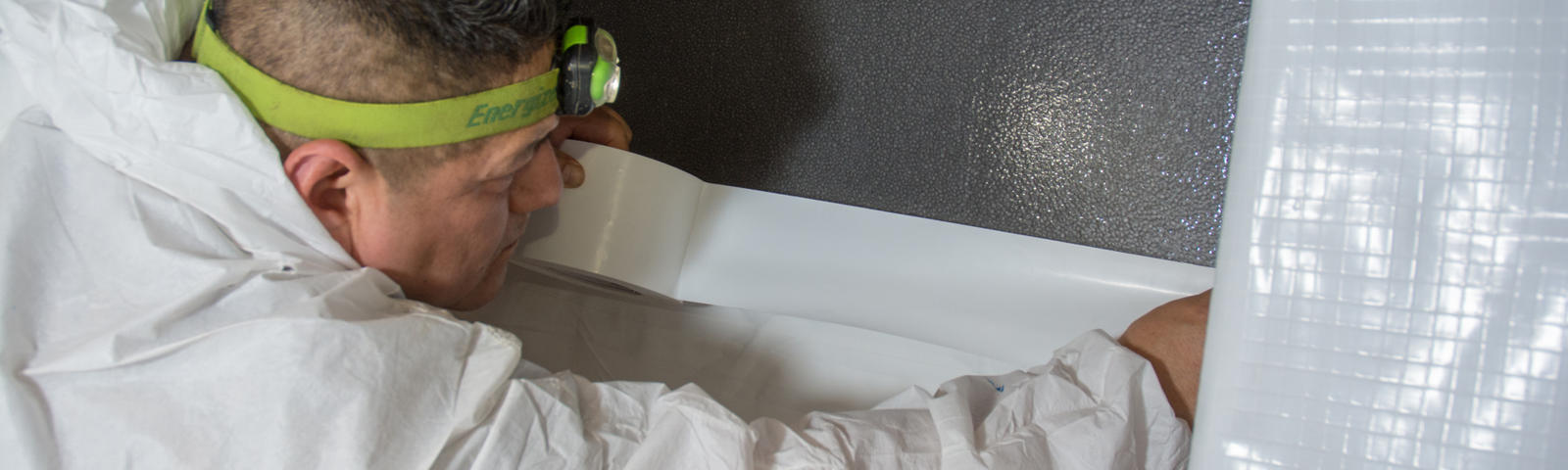 AFS crew member installing crawlseal tape.