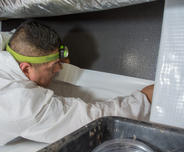 AFS crew member installing crawlseal tape.