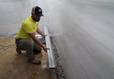 AFS crew member installing basement gutters.