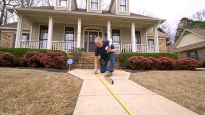 AFS CFI measuring sidewalk walkway.