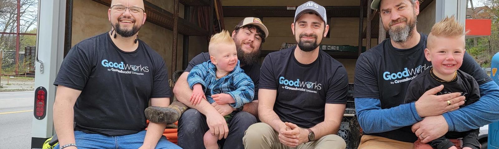 AFS crew members and family smiling while sitting in AFS truck.