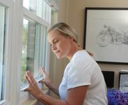 woman trying to open sticking window