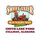 Sweet Tater Festival logo featuring a cartoon farmer on a tractor, held at Smith Lake Park, Cullman, Alabama.
