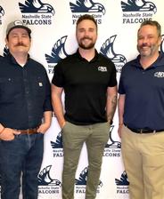 Three men standing in front of a Nashville State Falcons backdrop, smiling and wearing casual shirts.