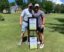 AFS team member Benjamin Worsham and his son at the Swing Fore Children with Cancer Golf Tournament