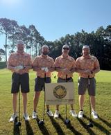 Four AFS crew members holding gold clubs at Aubreighs Army Lemon Face Classic sponsorship event