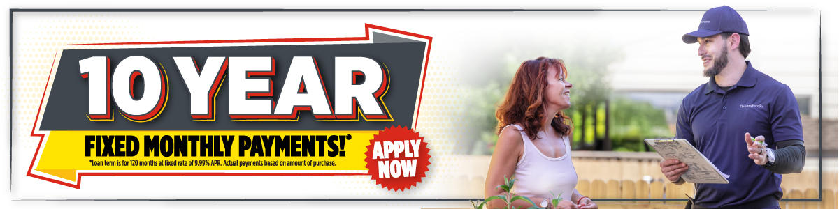 Banner reads "10 Year Fixed Monthly Payments* Apply Now" with a smiling woman and a man holding a waterproofing clipboard.