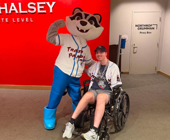 AFS team members son and the mascot for Dinosaur Weekend at Toyota Field during the Rocket City Trash Pandas game