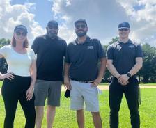 AFS Louisville employees stand on the golf course during the Ronald McDonald House Louisville’s Annual Golf Scramble