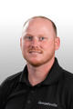 Meet The Team: Man with short red hair and beard, wearing a black “Groundworks” polo shirt, smiling at the camera.
