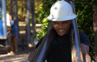 Foundation Systems of Michigan crew member carrying push piers while smiling.