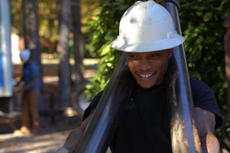 Foundation Systems of Michigan crew member carrying push piers while smiling.