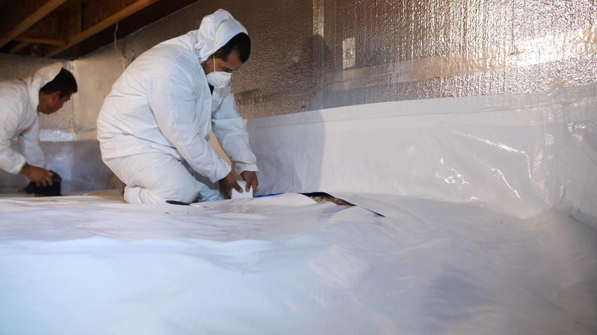 crew installing encapsulation in crawl space