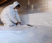 crew installing encapsulation in crawl space