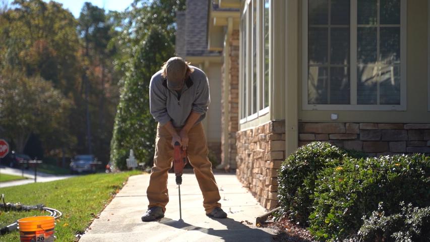 CFI drilling through concrete sidewalk.