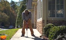 CFI drilling through concrete sidewalk.