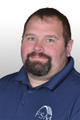 Man with short hair and beard wearing a blue polo with "FSM" logo, against a light background.