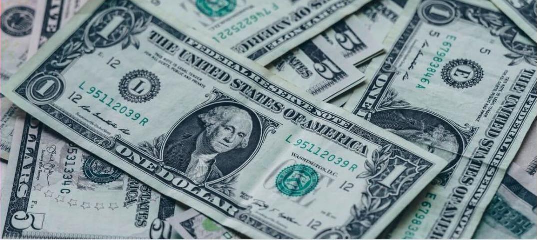 Pile of one and five dollar bills