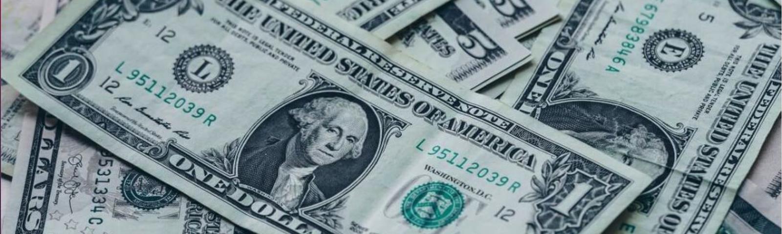 Pile of one and five dollar bills