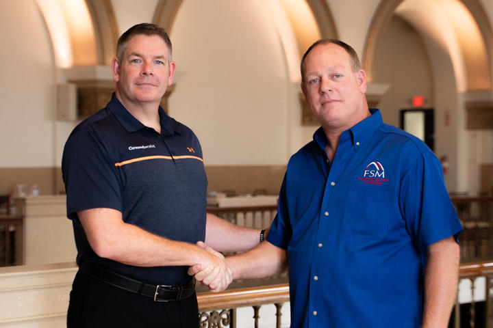 Matt Malone shaking hands with Bob Genord.