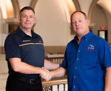 Matt Malone shaking hands with Bob Genord.