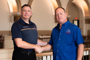 Matt Malone shaking hands with Bob Genord.