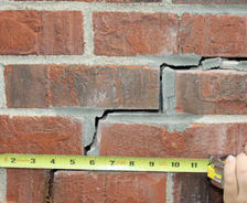 Stair step crack in exterior wall.
