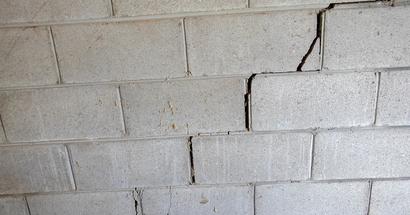 Stair-step settlement crack in basement wall