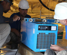 FSM crew members installing dehumidifier.